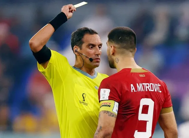 Aleksandar Mitrovic of Serbia is shown a yellow card by referee Fernando Andres Rapallini of Argentina during the FIFA World Cup Qatar 2022 Group G match between Serbia and Switzerland at Stadium 974 on December 02, 2022 in Doha, Qatar. (Photo by Hannah Mckay/Reuters)