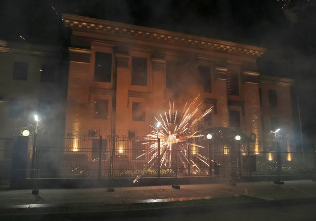 Fireworks launched by protesters, explode near the Russian embassy during the protest against Russian plans to hold parliamentary elections in annexed Crimea, in Kiev, Ukraine, September 17, 2016. (Photo by Gleb Garanich/Reuters)