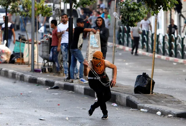 A Palestinian protester gestures during clashes with Israeli troops in the West Bank city of Hebron September 19, 2016. (Photo by Mussa Qawasma/Reuters)