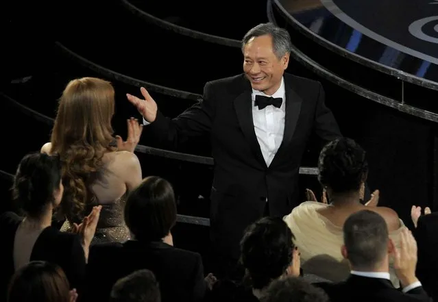 Ang Lee walks on stage to accept the award for best director for “Life of Pi”. (Photo by Chris Pizzello/Invision)