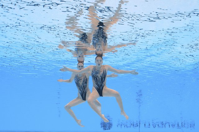 Arina Pushkina and Yasmin Tuyakova of Kazakhstan compete in the women's duet technical preliminary of artistic swimming at the World Aquatics Championships in Singapore, Friday, July 18, 2025. (Photo by Lee Jin-man/AP Photo)