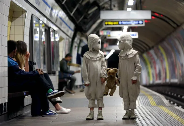 Actors dressed as The Twins from the new Tim Burton film, Miss Peregrine’s Home for Peculiar Children, travel on London Underground, ahead of the launch of the new movie in London, England on September 26, 2016. (Photo by Matt Alexander/PA Wire)