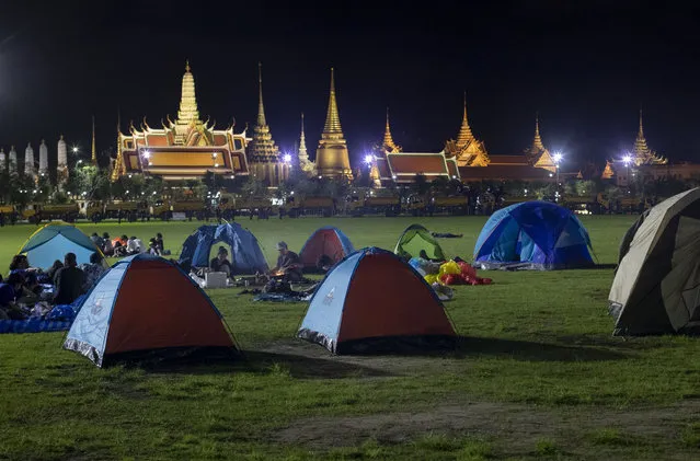 Pro-democracy protesters who occupied Sanam Luang, a historic field for an over-night protest rally, cook a meal in Bangkok, Thailand, early Sunday, September 20, 2020. (Photo by Gemunu Amarasinghe/AP Photo)