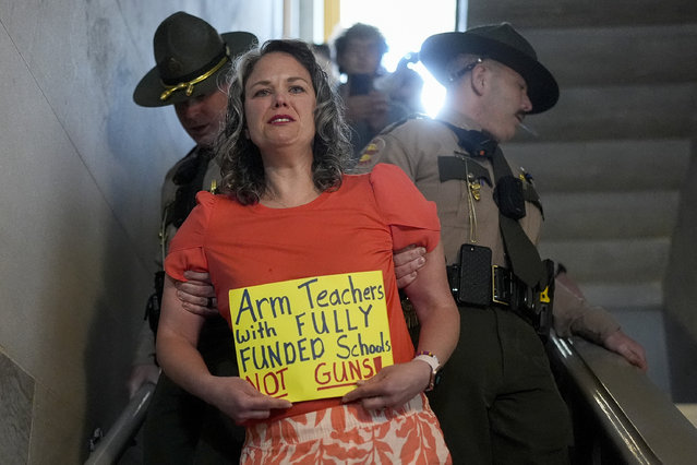 Allison Polidor, a gun control advocate, is escorted out of a legislative hearing room by state troopers, as families waited to testify in favor of gun control measures, in Nashville, Tenn., April 18, 2024. (Photo by George Walker IV/AP Photo)