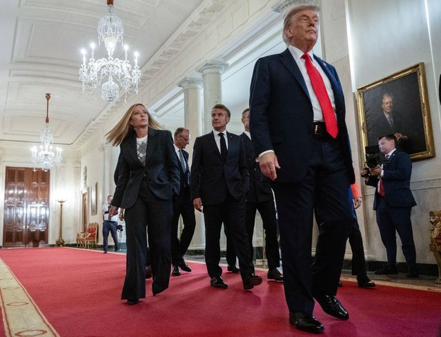 Italian Prime Minister Giorgia Meloni, German Chancellor Friedrich Merz, French President Emmanuel Macron, and US President Donald Trump walk through the Cross Hall to the East Room on their way to meet with Ukrainian President Volodymyr Zelensky and European leaders at the White House in Washington, DC, on August 18, 2025. European leaders join Ukrainian President Volodymyr Zelensky in talks with US President Donald Trump on August 18, as they try to find a way to end Russia's offensive. The leaders heading to Washington on Monday to appear alongside Zelensky call themselves the “coalition of the willing”. (Photo by Andrew Caballero-Reynolds/AFP Photo)