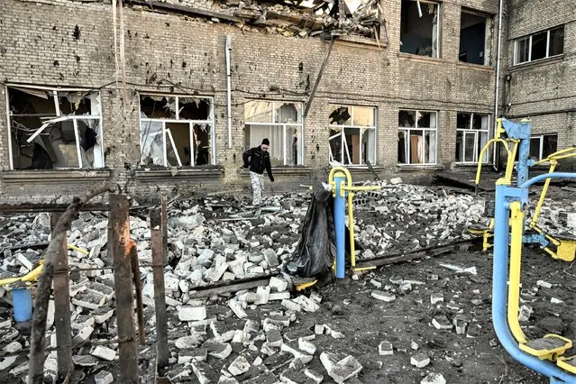 A man walks outside a destroyed school after a missile strike in Kramatorsk, Dombass regions, on March 6, 2023, amid Russian invasion of Ukraine. (Photo by Aris Messinis/AFP Photo)