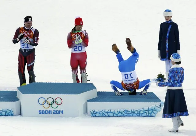 Third-placed Italy's Christof Innerhofer (2nd R) does a somersault on the podium as winner Switzerland's Sandro Viletta (2nd L) and second-placed Croatia's Ivica Kostelic (L) laugh after the men's alpine skiing super combined event at the 2014 Sochi Winter Olympics at the Rosa Khutor Alpine Center in this February 14, 2014 file photo. (Photo by Stefano Rellandini/Reuters)