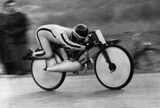 Italian motorcyclist Raffaele Alberti at speed on his strange-looking 75cc Moto Guzzi during his successful attempt at the world motorcycle speed record, on the road between Charrat and Saxon in Switzerland on March 1, 1949. (Photo by Keystone/Getty Images)