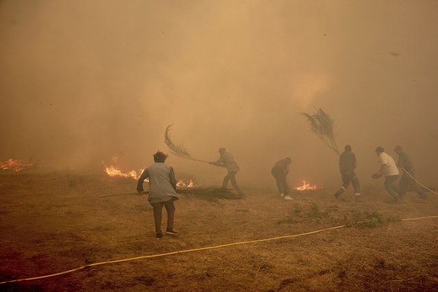 Residents battle a fire advancing toward Rebordondo village, near Ourense, in northwestern Spain, on Monday, August 18, 2025. (Photo by Pablo Garcia/AP Photo)