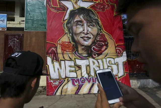 A supporter takes a picture of a graffiti of Myanmar pro-democracy leader Aung San Suu Kyi in front of the National League for Democracy (NLD) head office in Yangon November 13, 2015. The party of Suu Kyi has won a majority in Myanmar's parliament, the election commission said on Friday, giving it enough seats to elect the new president. (Photo by Soe Zeya Tun/Reuters)