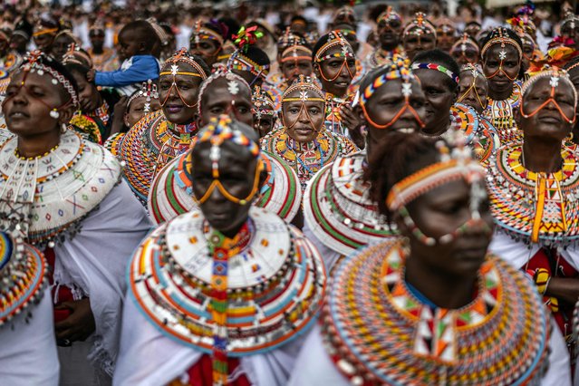 Samburu women gather to perform traditional dances in celebration after a camel race during the 32nd Maralal International Camel Derby celebrations in Maralal on September 26, 2025. The 32nd Maralal International Camel Derby brought together 37 professional pastoralist riders from the Samburu, Turkana, and Rendille communities, some travelling over 150 km with their camels to compete. Beyond the prestigious money prize, the event serves as an important showcase of culture, attracts global visitors, boosts local tourism, and fosters peace among communities historically divided by resource conflicts in a region harshly affected by climate change. (Photo by Luis Tato/AFP Photo)