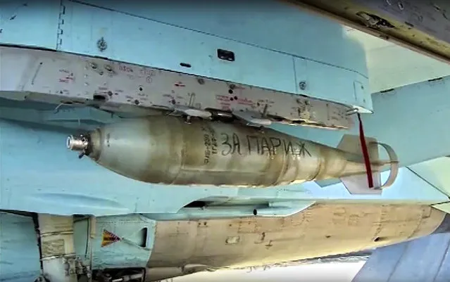 In this photo made from video released by Russian Defense Ministry official web site on Friday, November 20, 2015, "For Paris" is written on a bomb attached to a Russian war plane in preparation for a combat mission in Syria, according to information released by Russian Defense Ministry. (Photo by AP Photo/ Russian Defense Ministry Press Service)