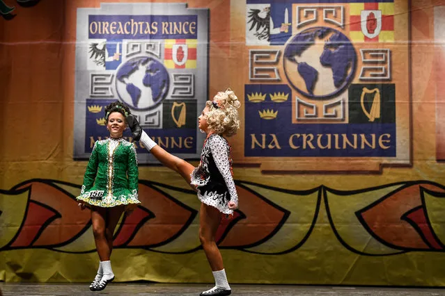 A competitor high kicks across the stage as she takes part in the World Irish Dancing Championships on March 25, 2018 in Glasgow, Scotland. The World Irish Dancing Championships are taking place in Glasgow this week at the Royal Concert Hall, with more than 14,500 dancers and supporters expected to travel to the championships which has run for more than forty years. (Photo by Jeff J. Mitchell/Getty Images)