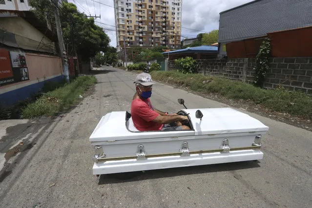 Gabriel Berendo, a businessman and car enthusiast, drives a casket converted into a car on Sunday May 31, 2020 in Cebu city, central Philippines as he goes around streets to remind residents to stay at home as lockdown measures to prevent the spread of the new coronavirus eases next week. (Photo by AP Photo/Stringer)