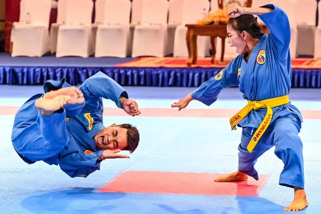 Cambodia’s Meth Sopheaktra and Pal Chhor Raksmy perform in the women's Vovinam self-defense event during the 32nd Southeast Asian Games (SEA Games) in Phnom Penh on May 8, 2023. (Photo by Tang Chhin Sothy/AFP Photo)