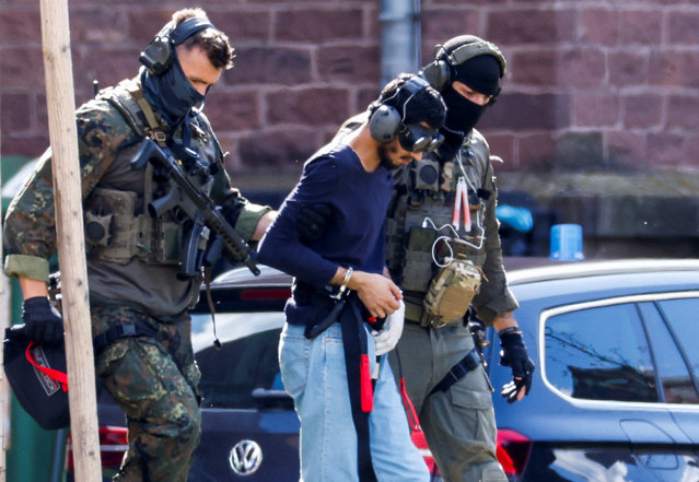 A 26-year-old Syrian man, who is the suspect in custody for a stabbing rampage in the western German city of Solingen in which several individuals were killed, is escorted by police as he leaves the Federal Public Prosecutor in Karlsruhe, Germany, on August 25, 2024. (Photo by Heiko Becker/Reuters)