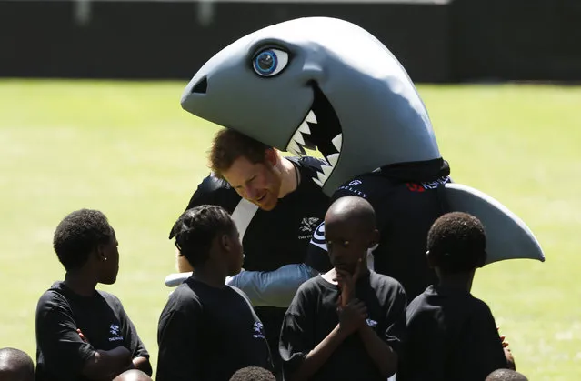 Britain's Prince Harry gets close to Sharks' rugby mascot Sharky during a training session in Durban, South Africa December 1, 2015. Prince Harry is in South Africa on behalf of Sentebale, the charity he founded with Lesotho's Prince Seeiso in memory of their mothers. (Photo by Rogan Ward/Reuters)