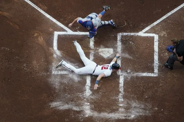 Atlanta Braves' Sean Murphy (12) scores on an Austin Riley double as the ball gets past Los Angeles Dodgers catcher Will Smith (16) during the first inning of a baseball game Tuesday, May 23, 2023, in Atlanta. (Photo by John Bazemore/AP Photo)