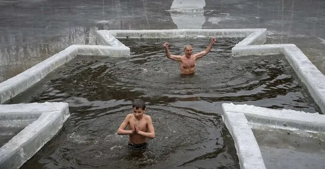 People take a dip in a lake during Orthodox Epiphany celebrations in Kiev January 19, 2015. (Photo by Gleb Garanich/Reuters)