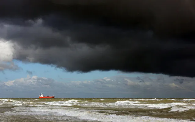A ship is moored seeking shelter beneath stormy skies in the English Channel off the coast of Margate, south eastern England, Wednesday October 14, 2015. (Photo by Gareth Fuller/PA Wire via AP Photo)