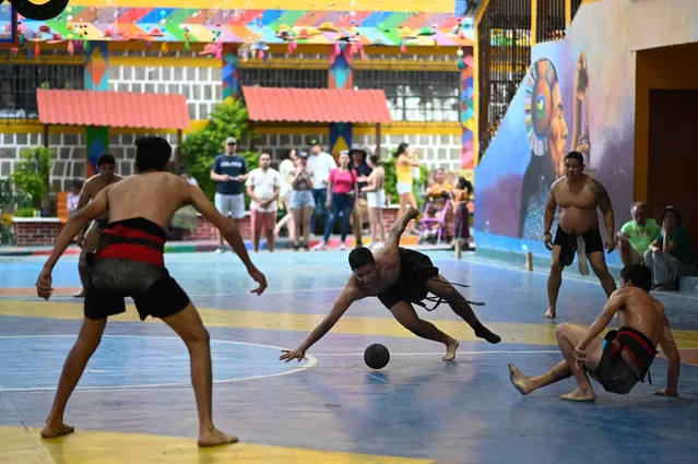 A Salvadoran player plays a Mayan ball game match against Honduras at San Juan La Laguna, Guatemala, on June 3, 20223, during the Third Central American Mayan Ball Game Tournament. Teams from Guatemala, Honduras, and El Salvador taking part in the tournament seek to keep this ancestral game alive. (Photo by Johan Ordonez/AFP Photo)