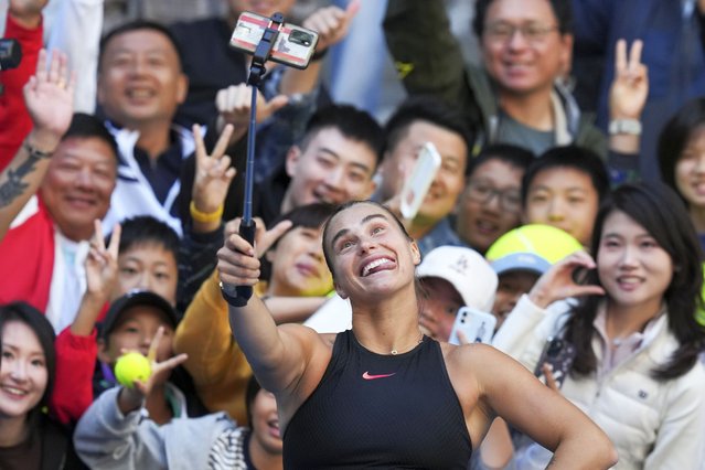 Aryna Sabalenka of Belarus takes a selfie with fans after winning against Madison Keys of the United States during their women's singles match of the China Open tennis tournament, at the National Tennis Center in Beijing, Wednesday, October 2, 2024. (Photo by Achmad Ibrahim/AP Photo)