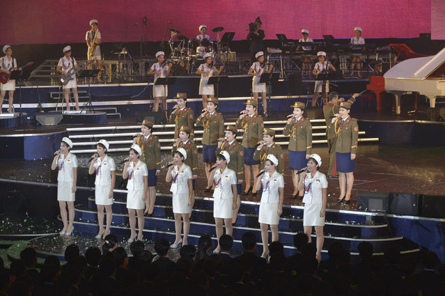 Members of the Moranbong Band and the State Merited Chorus take part in a joint performance to celebrate the 68th anniversary of the Workers' Party of Korea (WPK) in this undated photo released by North Korea's Korean Central News Agency (KCNA) in Pyongyang October 11, 2013. (Photo by Reuters/KCNA)