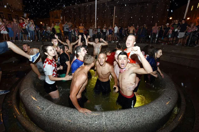 Croatia' s fans celebrate victory against Russia in the Croatian capital Zagreb' s main square after the 2018 FIFA World Cup Russia Round of 8 match between Russia and Croatia on July 7, 2018. (Photo by Denis Lovrovic/AFP Photo)