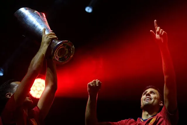 Spain's midfielder Mikel Merino (L) and Spain's midfielder Rodrigo Hernandez celebrate with the trophy during celebrations at the WiZink centre in Madrid on June 19, 2023 one day after Spain won the UEFA Nations League final footbal. (Photo by Oscar del Pozo/AFP Photo)