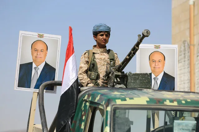 A police trooper mans a machine gun mounted on a patrol truck securing a street where people loyal to Yemen's President Abd-Rabbu Mansour Hadi demonstrated to show support to Hadi in the country's northern city of Marib November 3, 2016. (Photo by Ali Owidha/Reuters)