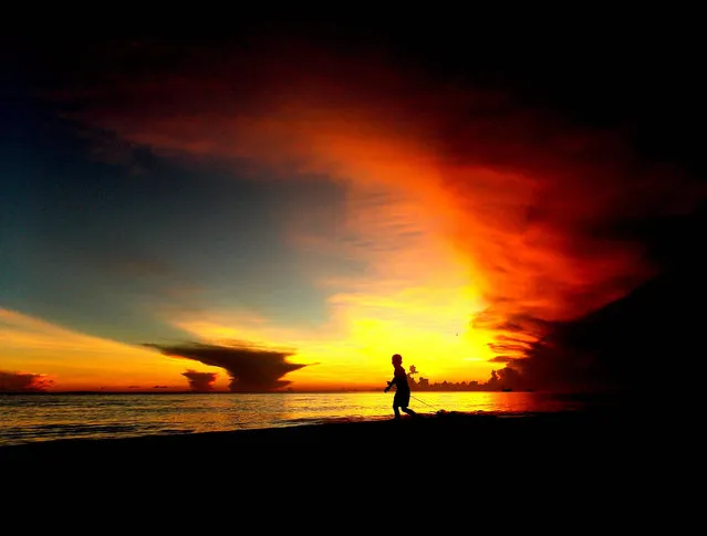 A Filipino villager boy frolic as the sun sets at the resort island of Boracay, Philippines, 25 May 2018. According to Environment Secretary Roy Cimatu, at least 100 soldiers from the military will help in removing the illegal pipes and assist the inter-agency task force in meeting the scheduled re-opening of the Philippines' famous Boracay Island. Boracay was ordered closed by President Duterte for six months starting from 26 April 2018, to give way to its cleanup and rehabilitation. The tourist hotspot was labelled by President Rodrigo Duterte as a “cesspool” because of its water contamination. (Photo by Jo Haresh Tanodra/EPA/EFE)