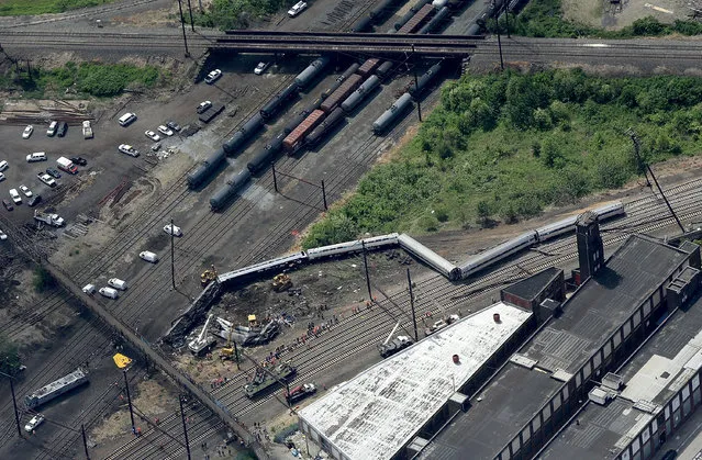 Investigators and first responders work near the wreckage of Amtrak Northeast Regional Train 188, from Washington to New York, that derailed yesterday May 13, 2015 in north Philadelphia, Pennsylvania. At least six people were killed and more than 200 others were injured in the crash. (Photo by Win McNamee/Getty Images)