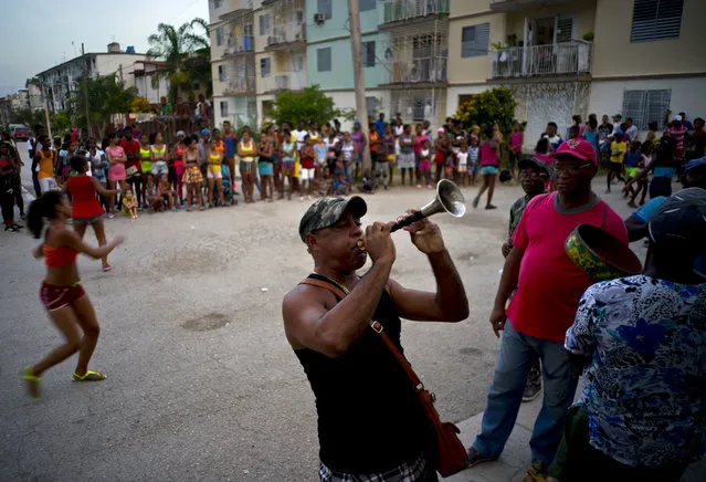 In this July 24, 2018 photo, residents practice ahead of the town's upcoming carnival celebrations in Guantanamo, Cuba, near the U.S. Guantanamo Bay naval base. Guantanamo's carnival, which runs Aug. 9-12, show cases parades of dancers, floats that compete for prizes, food stands and music. (Photo by Ramon Espinosa/AP Photo)