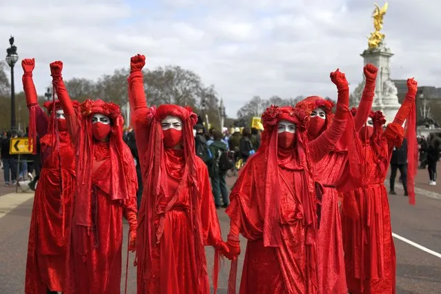 Extinction Rebellion activists perform during a “Kill the Bill” protest in London, Saturday, April 3, 2021. (Photo by Alberto Pezzali/AP Photo)