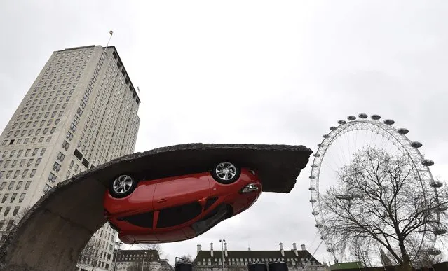 An upside down car art installation is seen in a car park on the South Bank in London, February 19, 2015. (Photo by Toby Melville/Reuters)