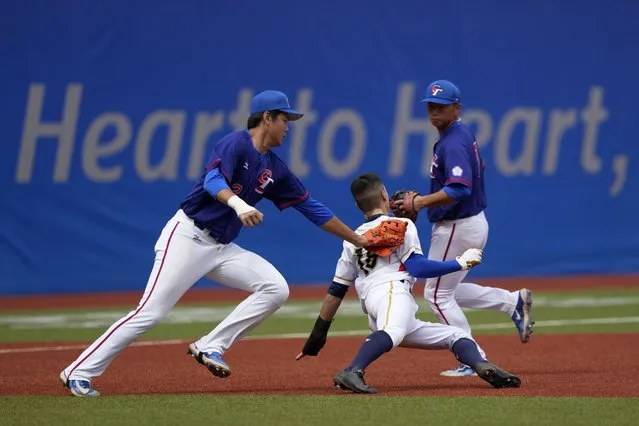 Taiwan's Lin Tzu-Hao tags out Hong Kong's Cheng Hoi Ting during a stage group round B Baseball Men game for the 19th Asian Games in Hangzhou, China on Tuesday, October 3, 2023. At the Asian Games China has been going out of its way to be welcoming to the Taiwanese athletes, as it pursues a two-pronged strategy with the goal of taking over the island, which involves both wooing its people while threatening it militarily. (Photo by Ng Han Guan/AP Photo)