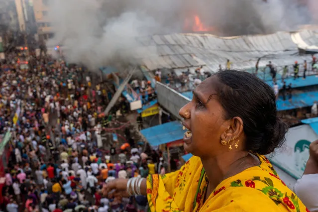 A woman reacts after a fire broke out at the Mohammadpur Krishi Market in, Dhaka, Bangladesh on September 14, 2023, in this picture obtained from social media.(Photo by Arshadul Hoque Rocky via Reuters)