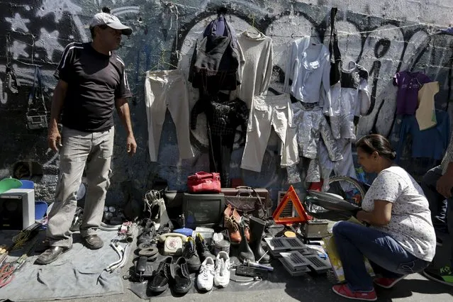 A man sells used items at his improvised store at a main street in Caracas, January 25, 2016. (Photo by Marco Bello/Reuters)