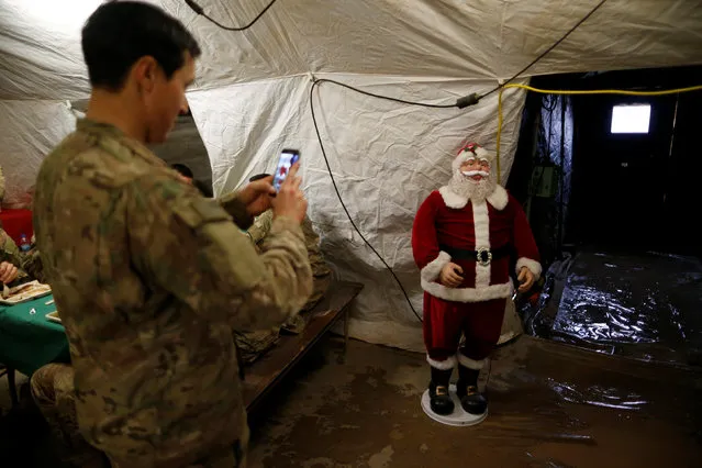 U.S. soldiers enjoy a Christmas dinner at an army base in Karamless town, east of Mosul, December 25, 2016. (Photo by Ammar Awad/Reuters)