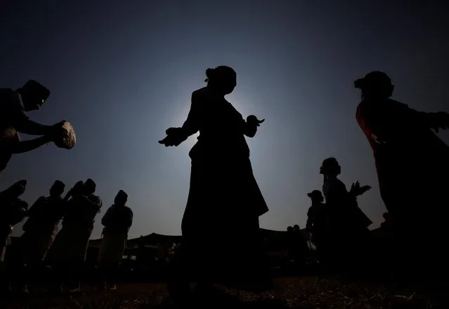 A Gurung girl (C) wearing a traditional costume is silhouetted against the sun as she dances while taking part in their Tamu Lhosar or Losar (New Year) parade in Kathmandu, Nepal December 30, 2016. (Photo by Navesh Chitrakar/Reuters)