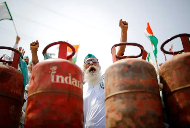 A farmer shouts slogans during a protest against the hike in fuel prices, at the Delhi-Uttar Pradesh border in Ghaziabad, India, July 8, 2021. (Photo by Adnan Abidi/Reuters)