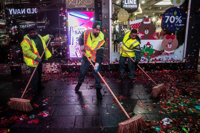 Workers clean up the streets after New Year’s Eve celebrations in Times Square, New York City, US on January 1, 2019. (Photo by Jeenah Moon/Reuters)