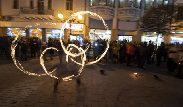 A Bulgarian artist performs with fire balls during the opening ceremony for the European Capital of Culture 2019 in Plovdiv, Bulgaria, 12 January 2019. The town of Plovdiv holds the title of European Capital of Culture 2019 since January 2019, along with the city of Matera, in Italy. (Photo by Vassil Donev/EPA/EFE)