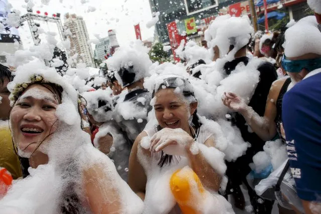 Revellers use water guns as they participate in a water fight during Songkran Festival celebrations at Silom road in Bangkok April 13, 2015. (Photo by Athit Perawongmetha/Reuters)