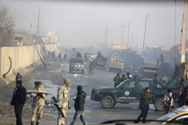 Afghan security forces gather at the site a day after an attack in Kabul, Afghanistan, Tuesday, January 15, 2019. A Taliban suicide bomber detonated an explosive-laden vehicle in the capital Kabul on Monday evening, according to officials. (Photo by Rahmat Gul/AP Photo)
