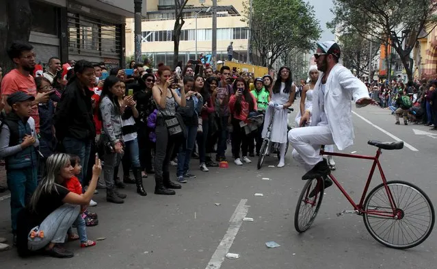 A performer takes part in a street parade as part of the opening ceremony of the Ibero-American Theater Festival in Bogota, Colombia, March 12, 2016. (Photo by John Vizcaino/Reuters)
