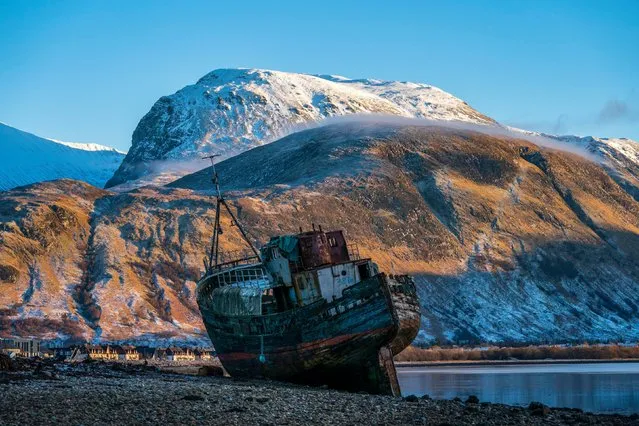 Ben Nevis looms over the wreck of the Golden Harvest fishing boat on the banks of Loch Linnhe near Fort William in the western Scottish Highlands on Thursday, January 11, 2024. (Photo by Jane Barlow/PA Images via Getty Images)