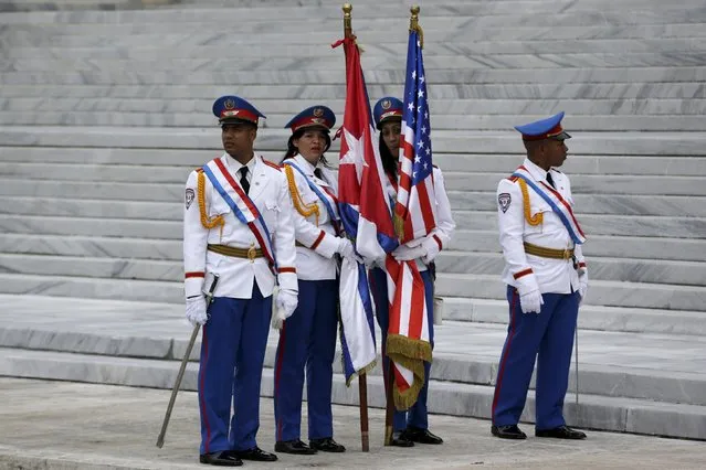 Honor guards carry the U.S. and Cuban flags as they stand at the bottom of the stairs of the Revolution Palace during a visit by U.S. President Barack Obama in Havana, Cuba March 21, 2016. (Photo by Ivan Alvarado/Reuters)