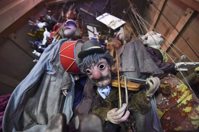 Puppets hang in Lambert's Puppet theatre in Dublin, Ireland, March 23, 2016. Lambert's Puppet theatre was established by Liam's father 44 years ago and is Ireland's only and oldest purpose-built puppet theatre. Last September, the theatre and its many of its antique puppets were damaged in an arson attack. The theatre, for which Liam crafts all the puppets by hand and performs every show has seen a resurgence in audiences since recovering from the fire. (Photo by Clodagh Kilcoyne/Reuters)