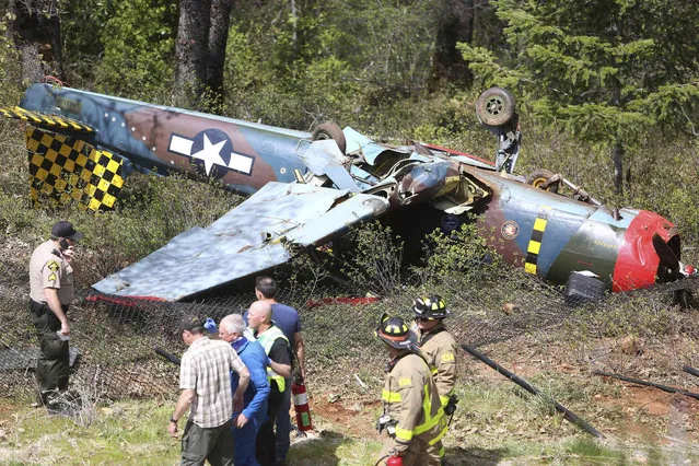 The fuselage of a 1989 Nanchang CJ-6 sits upside down and damaged after a braking system failure sent the plane over the end of the runway at the Nevada County Airport Friday, April 19, 2019, in Grass Valley, Calif. The two occupants of the plane sustained minor injuries and were able to walk away from the crash. (Photo by Elias Funez/The Union via AP Photo)